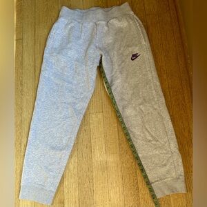Nike gray sweatpants with dark purple logo, cuffed bottom and stretchy waistband